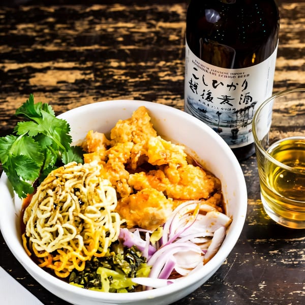 Oki Shōten's Japanese bowl with crispy chicken, noodles, cilantro, onions, and a bottle of Echigo beer.