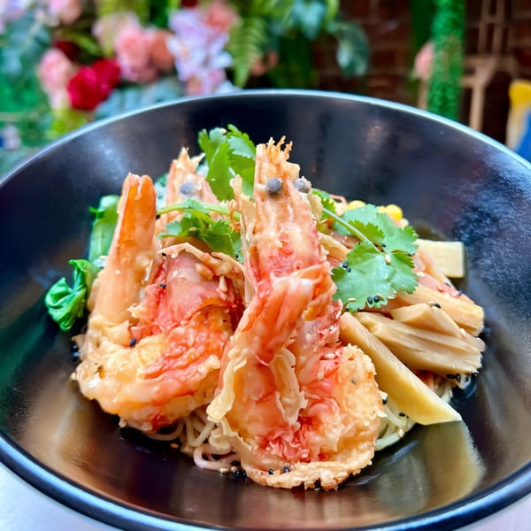 Oki Shōten's tempura shrimp ramen bowl with bamboo shoots, corn, and cilantro.